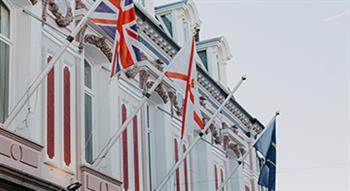 Photo of Jersey and UK flags outside building