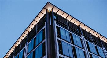 Photo of corner of building with ights on shot at dusk in blue light